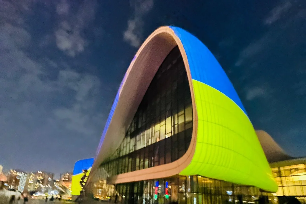The Heydar Aliyev Center is illuminated by the colors of the Ukrainian flag