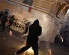 Police clash with masked rioters after largely peaceful protests across France