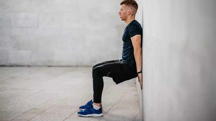The Isometric Wall Sit Challenge That Will Set Your Quads on Fire