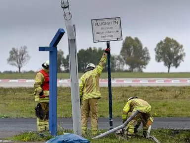 German authorities investigate a hole cut into a fence at Leipzig airport