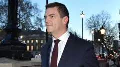 Ex-top official Robbins reaches settlement with government over sacking