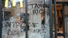 Burnt out cars and shattered glass on Paris streets after protests turn to riots and looting